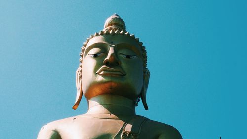 Low angle view of statue against blue sky