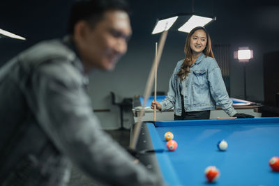 Midsection of man playing pool