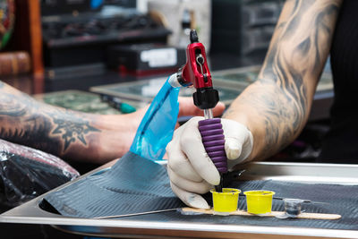 Midsection of man working at machine