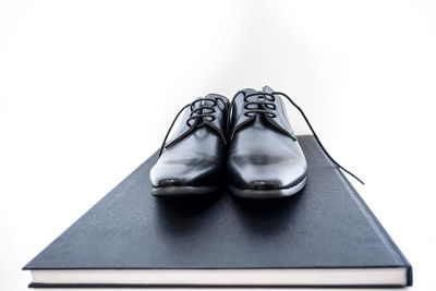 High angle view of shoes on floor against white background