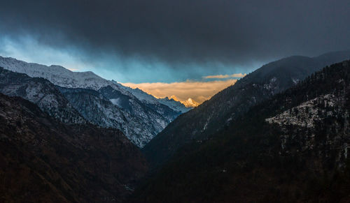 Scenic view of snowcapped mountains against sky during sunset