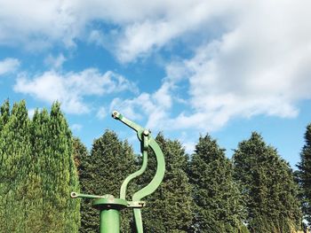 Low angle view of trees against blue sky