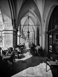 People in restaurant against building