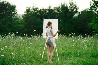 Full length of woman standing on field