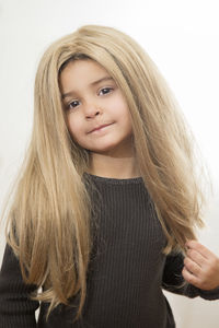 Portrait of beautiful young woman against white background