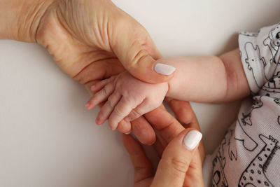 Cropped hand of person gesturing against white background