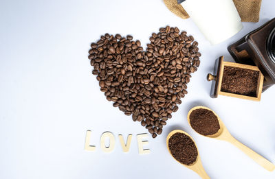 High angle view of coffee beans against white background