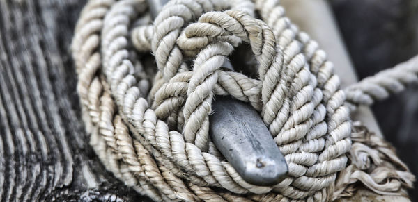 Close-up of rope tied on wooden post