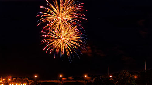 Low angle view of firework display at night