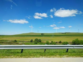 Windmill on field against sky