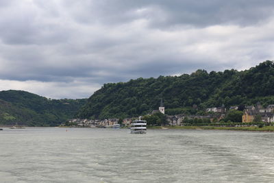 Scenic view of lake against sky in city