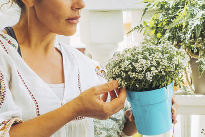 Close-up of woman holding potted plant