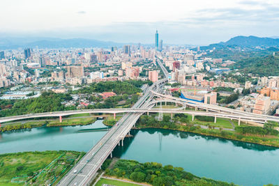 High angle view of bridge over river in city against sky