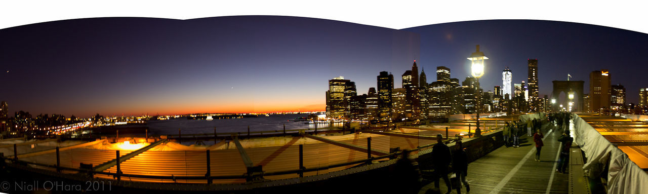 VIEW OF ILLUMINATED CITYSCAPE AT NIGHT