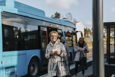 Smiling woman at bus station