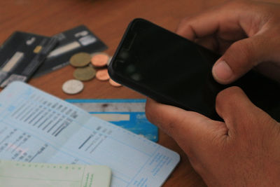 Midsection of man using mobile phone
