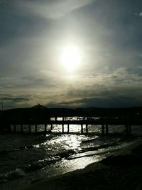 Pier on sea at sunset