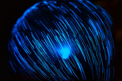 Close-up of light painting against black background