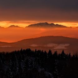 Scenic view of silhouette mountains against sky during sunset