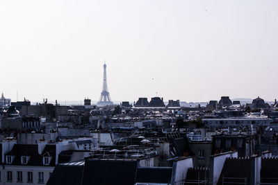 Buildings in city against clear sky