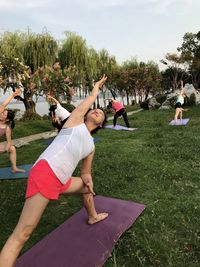 People exercising on grass