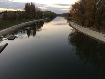 Reflection of trees in water against sky