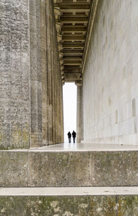 People walking on wall of building