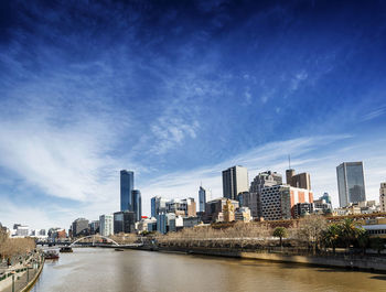 River amidst buildings against sky in city