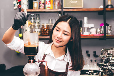 Young woman with drink on table