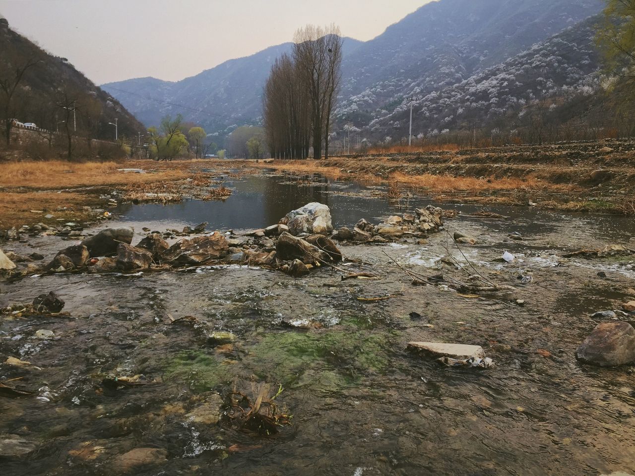 mountain, water, tranquil scene, tranquility, scenics, beauty in nature, lake, nature, river, landscape, rock - object, mountain range, non-urban scene, tree, stream, reflection, idyllic, sky, remote, day