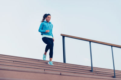 Confident woman exercising in city