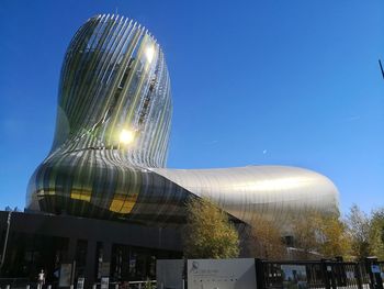 Low angle view of modern buildings against blue sky