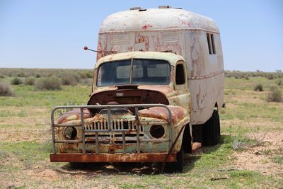 Abandoned car on field