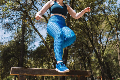 Low section of woman standing on rock