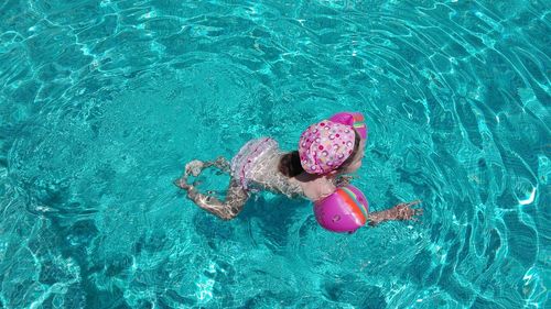 High angle view of girl swimming in pool