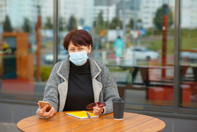 Portrait of woman with coffee cup in cafe