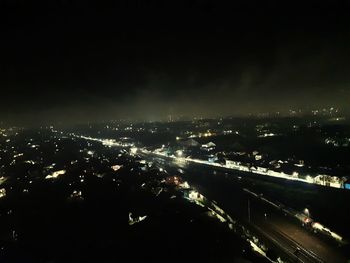 High angle view of illuminated city buildings at night