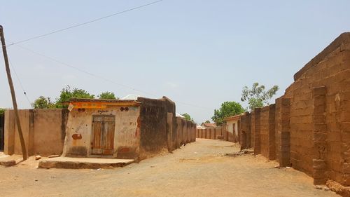 View of small hut in village against clear sky