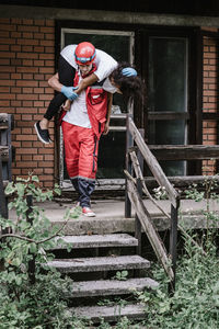 Full length of man standing on staircase against building