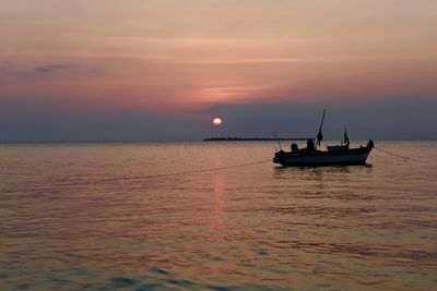 Sailboat on sea against sky during sunset