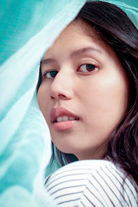 Close-up portrait of young woman looking away