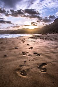 Scenic view of beach against sky during sunset