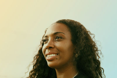 Portrait of a smiling young woman looking away