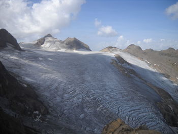 Scenic view of sea and mountains against sky