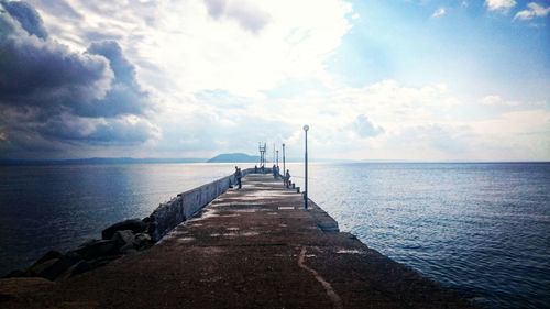 Pier over sea against sky