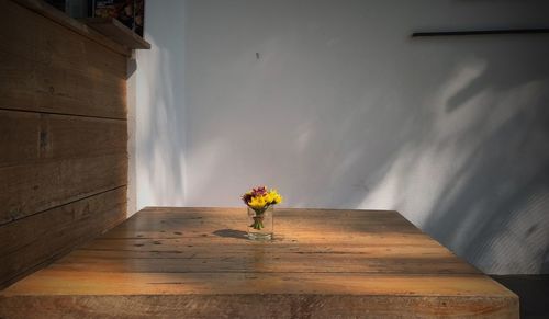 Flower vase against wall in building