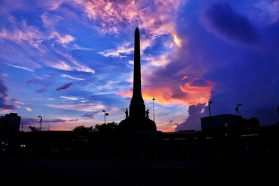 Low angle view of silhouette building against sky during sunset