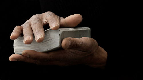 Black man praying to god on gray background with people stock image stock photo