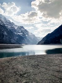 Scenic view of lake and mountains against sky