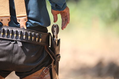 Rear view of man removing gun